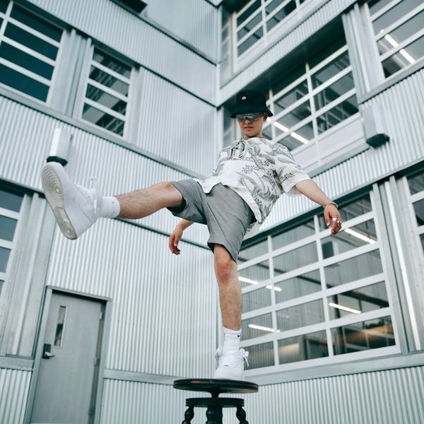 Person balancing on one leg in a yoga pose outdoors.
